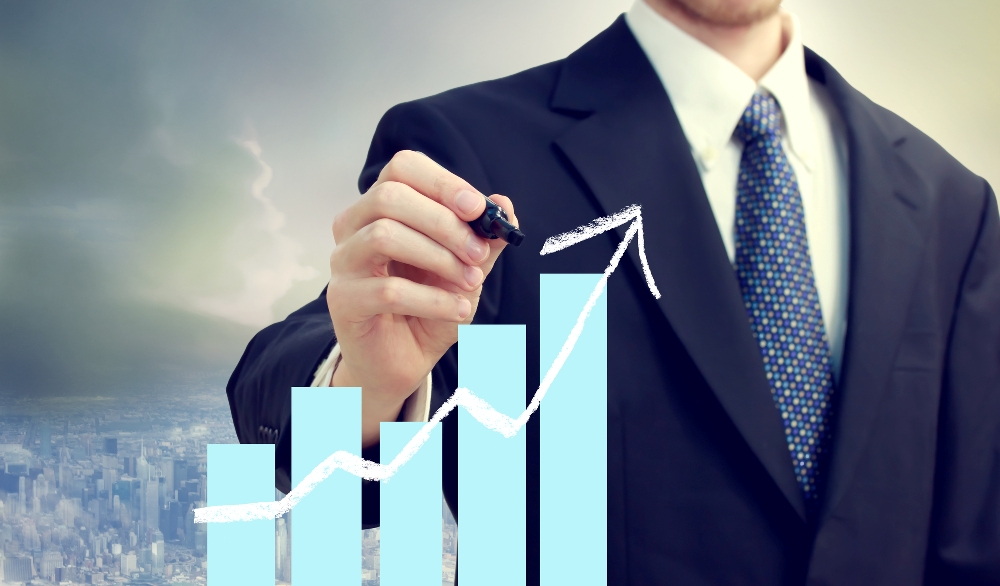 Home business man with chart showing growth